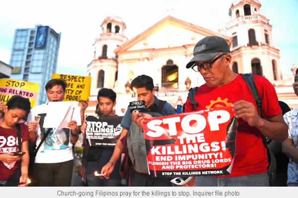 Church-going Filipinos pray for the killings to stop