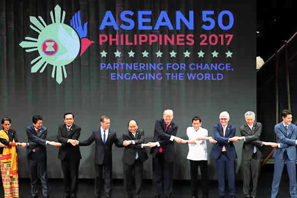 Heads of state give each other the traditional 'ASEAN handshake' during the ASEAN Summit opening ceremony held in Manila, on November 13, 2017