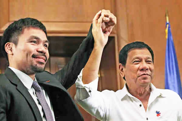 President Duterte raises the hand of Senator Pacquiao at Malacañan in December 2016